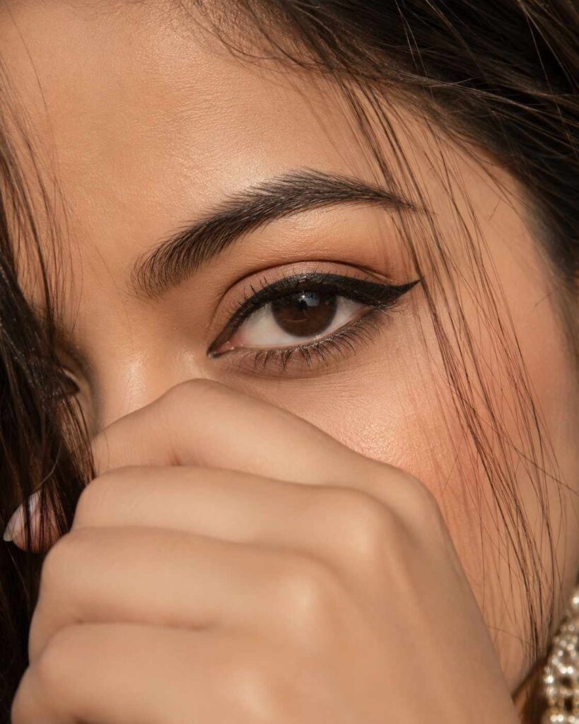Ultra-realistic cinematic macro close-up portrait of a single human eye with strict eye identity preservation, golden-hour lighting, and editorial beauty photography.